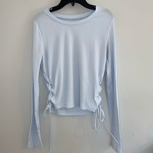 Blue long sleeved shirt with ties on the sides